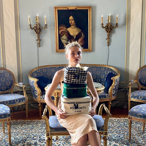 Large cream-colored beauty case from Bag-all displayed in elegant vintage setting with antique furniture. My Vanity Large Beauty Box features waterproof coated lining and spacious storage.