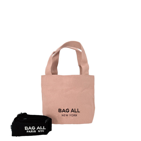 Bag-all Mini Tote Bag in blush pink cotton with adjustable black strap, interior pocket, and branded logo - versatile eco-friendly carrier for daily essentials