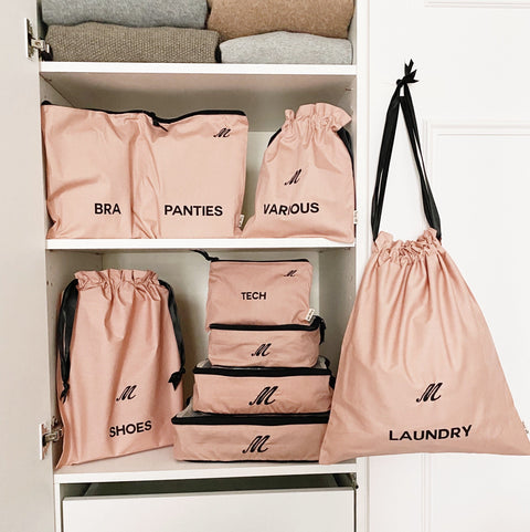 Bag-all BA Travel Set, 8-Pack in Pink/Blush with personalized monogram ‘M’. Includes packing cubes, shoe, laundry, tech, and various bags