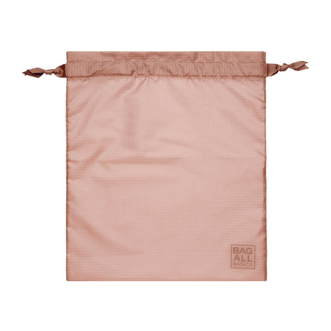 Bag-all recycled nylon packing bag in pink/blush with drawstring closure, part of 5-pack organization set, featuring eco-friendly material from repurposed bottles