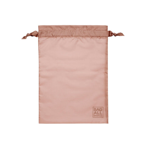 Bag-all recycled nylon packing bag in blush pink with drawstring closure and brand logo, part of 5-pack organizational set for travel and storage