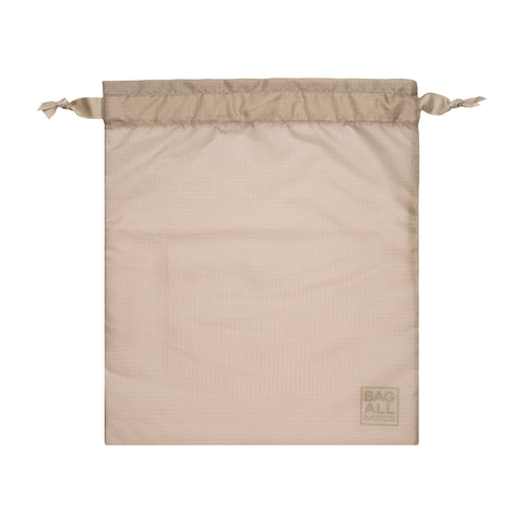 Bag-all Compression Cubes & Packing Bags Set in taupe, featuring a drawstring recycled nylon packing bag with subtle logo detail, perfect for organized travel