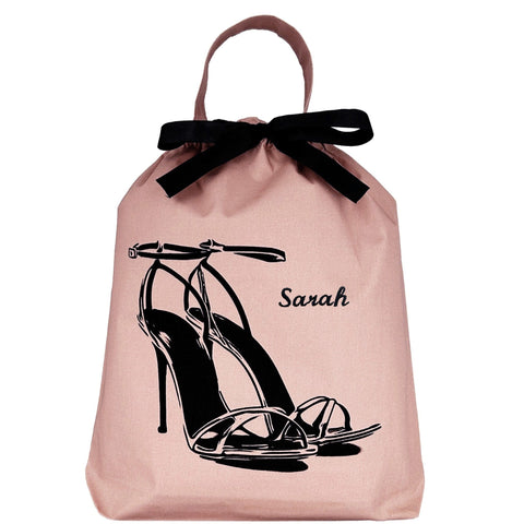 Bag-all pink blush high heel sandal shoe bag with black bow and elegant stiletto illustration, featuring protective cotton fabric and drawstring closure for travel and storage