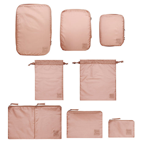 Bag-all Compression Cubes & Packing Bags Set in pink/blush features 8 sustainable travel organizers made from recycled nylon, including compression cubes and multipurpose storage bags