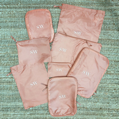 Bag-all Compression Cubes & Packing Bags Set in pink/blush with monogrammed SW initials, featuring 8 eco-friendly nylon organizers for efficient travel packing and storage
