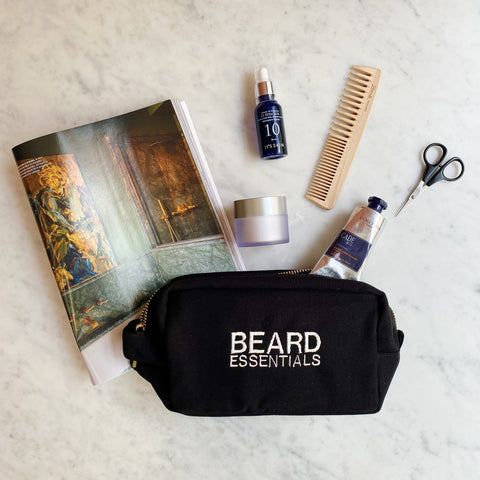 Bag-all Beard Essentials Pouch in black with grooming tools, beard oil, and comb. Stylish travel pouch for beard care products