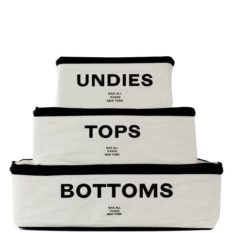 Bag-all Cotton Packing Cubes set of 3 in cream with black trim, labeled Undies, Tops, and Bottoms for organized travel storage, featuring mesh ventilation panel