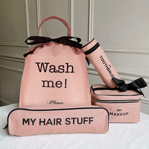 Bag-all Ultimate Gift Set in pink featuring laundry bag, makeup case, hair accessories pouch, and toothbrush holder with black bow accents and text labels
