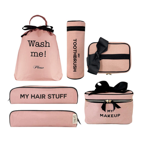 Bag-all Ultimate Gift Set featuring pink cotton travel cases: Wash Me laundry bag, makeup box, hair stuff case, and toothbrush holder with black bow accents