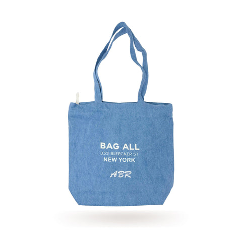 Bag-all New York City denim tote bag with zipper and inner pocket, featuring white logo print and Bleecker St address, classic blue washable cotton design