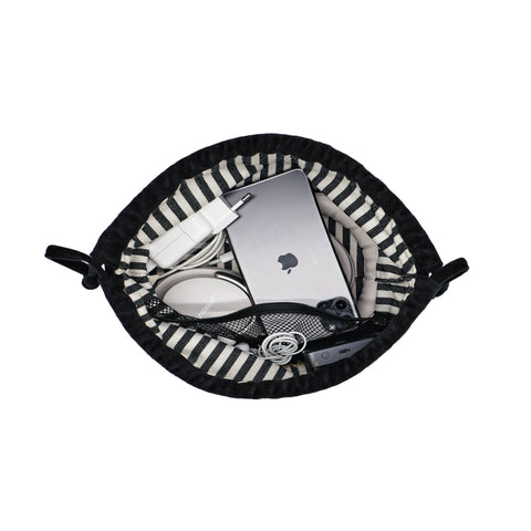 Drawstring black velvet tech pouch by Bag-all holding earbuds, charger, power bank, and cables neatly organized