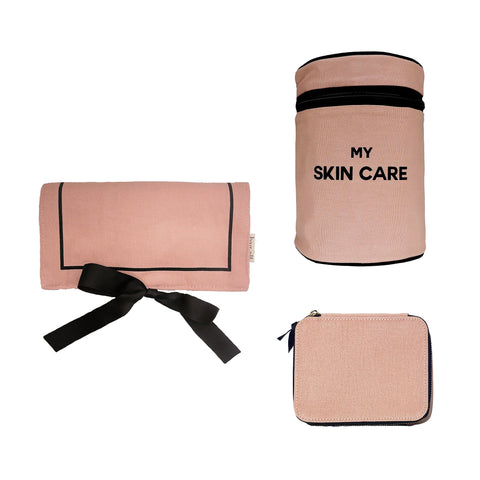 Bag-all Essential Gift Set Deal 3-Pack in pink featuring round skincare case, jewelry roll, and pill organizer. Premium cotton travel organizers with black trim and elegant design