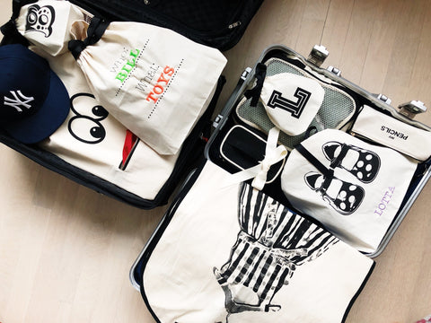 Bag-all Who What Bag in cream cotton canvas, featuring customizable monogram spaces for organized storage, perfect for versatile organization and personalized labeling of belongings