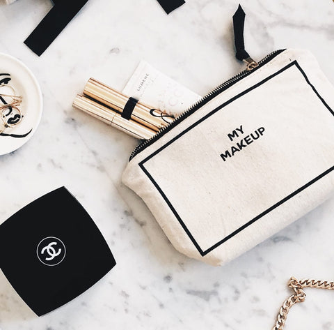 Bag-all My Makeup Pouch in cream canvas with black border text, waterproof lined makeup case shown with luxury cosmetics on marble surface, perfect for daily essentials and travel