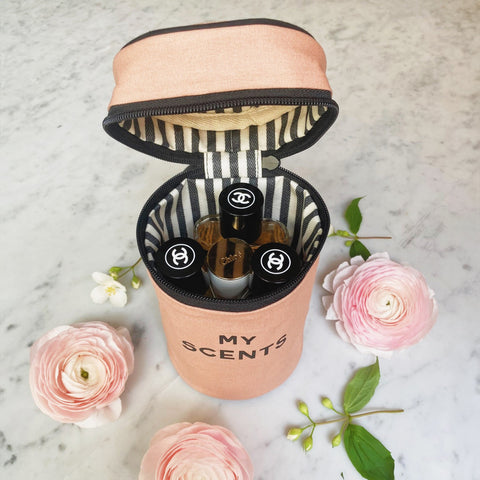 Bag-all Round My Scents Case in pink blush, cylindrical makeup organizer with striped interior lining, showing open case with perfume storage and elastic bands