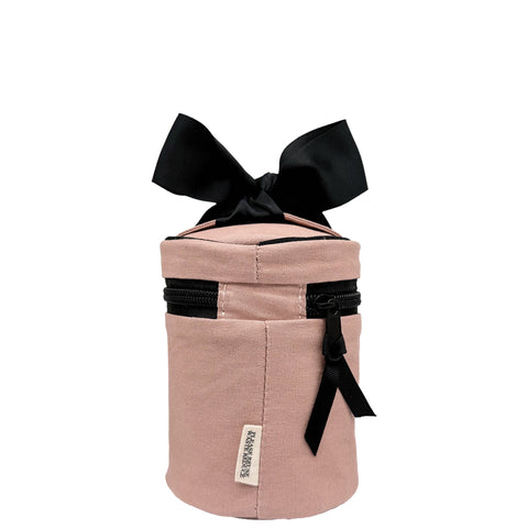Pink blush round carry on liquids case with black zipper and bow, designed for TSA compliance and travel organization