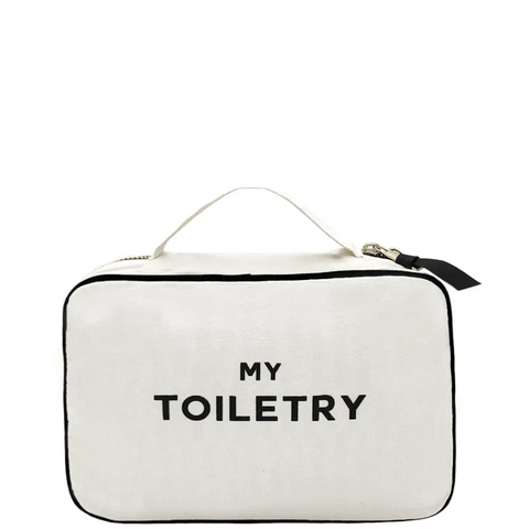 Bag-all Folding Toiletry Case in cream with 'MY TOILETRY' text, featuring black trim, hanging ribbon, and three compartments for organized travel storage