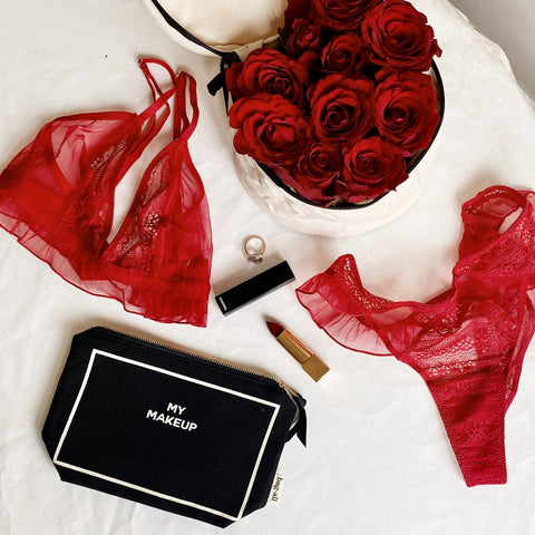 Bag-all My Makeup Pouch in black with waterproof lining, shown with red roses, lingerie, and beauty essentials. Stylish organizing case for makeup and brushes.
