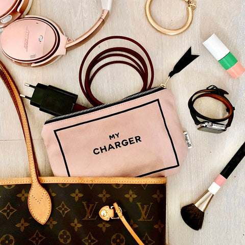 Bag-all Charger Pouch in blush pink with gold zipper shown with charging cables, headphones and accessories, perfect for organizing tech essentials in style