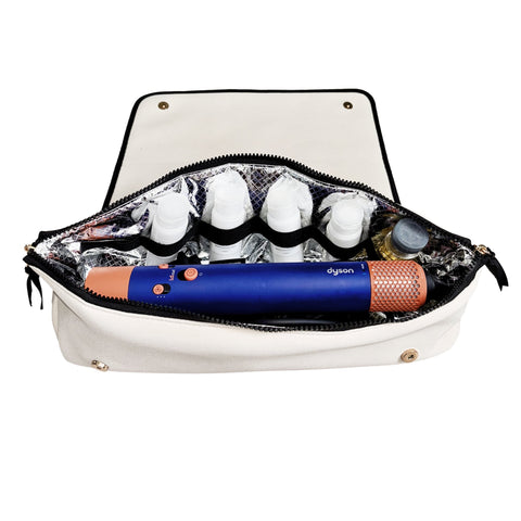 Cream travel case with heat-resistant mat holding hair tools and styling products neatly organized inside