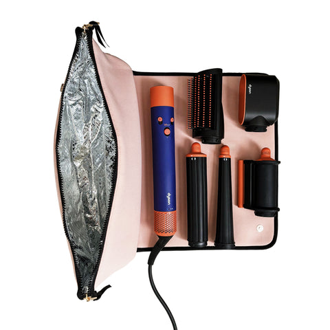 Pink travel case with heat-resistant mat holding a hair styling tool and interchangeable attachments neatly organized inside