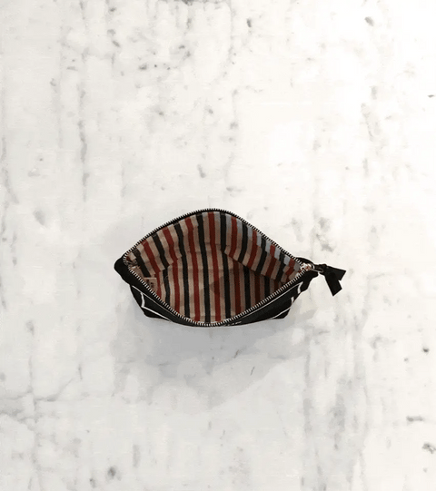 Bag-all My Makeup Pouch in cream with waterproof striped interior lining, open to show compact size and stylish organization for cosmetics and brushes