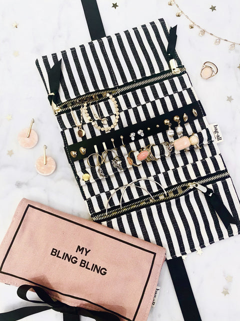 Bag-all Jewelry Organizer Travel Pouch featuring black and white striped interior, multiple compartments displaying organized jewelry, with blush pink case labeled "My Bling Bling" below