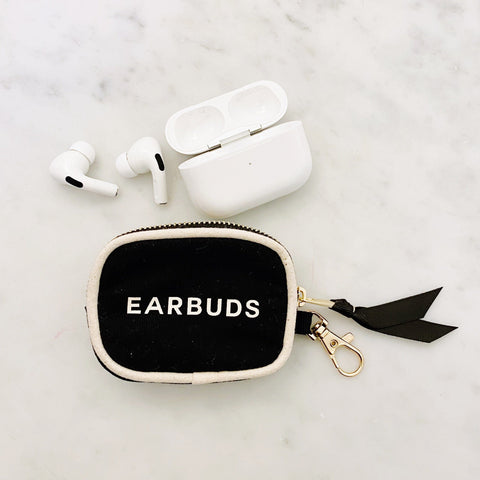 Bag-all Handbag Organizer Trio featuring black and white earbud case with gold zipper detail, shown with wireless earbuds and charging case on marble surface.