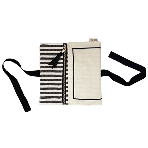 Bag-all Couture Jewelry Roll Medium in cream with striped interior lining, featuring three zip compartments, black trim details, and tie closure for elegant jewelry organization and travel