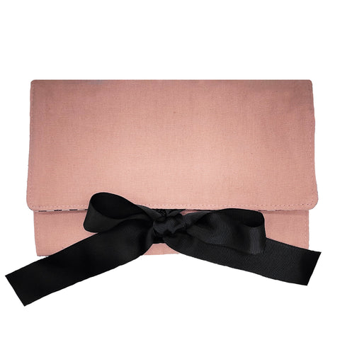 Bag-all Large Jewelry Roll in pink blush with elegant black bow, perfect for organizing and traveling with jewelry, featuring secure fold-over design and premium fabric construction