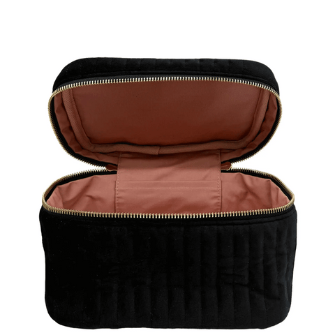Open black velvet quilted cosmetic box with brown interior and gold zipper for makeup storage