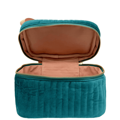Open quilted teal velvet makeup cosmetic box with beige interior and zipper closure visible