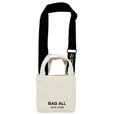 Bag-all Mini Tote Bag with Strap in cream cotton featuring adjustable black shoulder strap, interior pocket, and classic New York branding