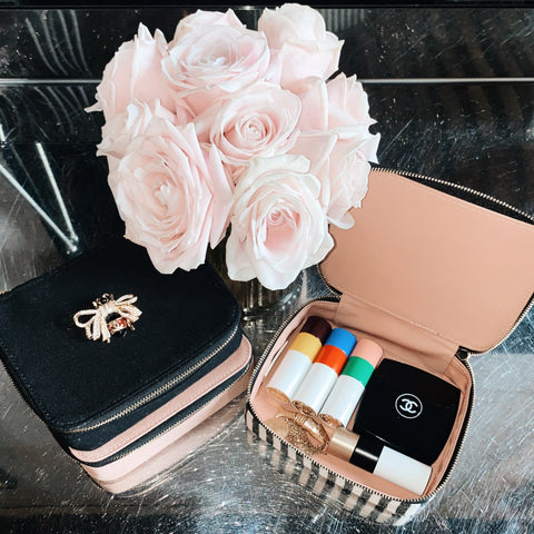 Bag-all Cosmetics/Trinket Box with striped design shown open displaying makeup items, alongside elegant pink roses and matching accessories on black surface