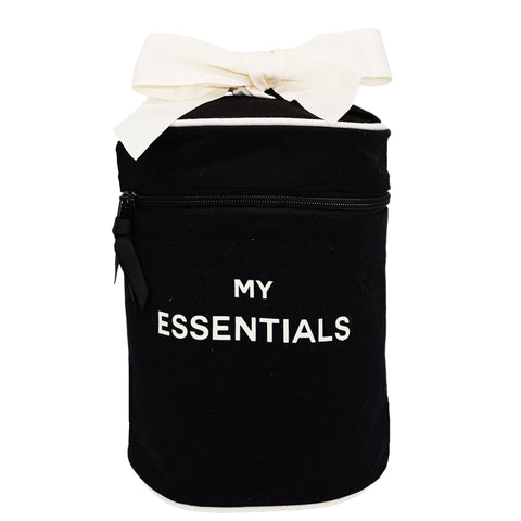 Bag-all Round Travel Essentials Case in black cotton with white bow and MY ESSENTIALS text, featuring coated lining and interior bands for secure storage