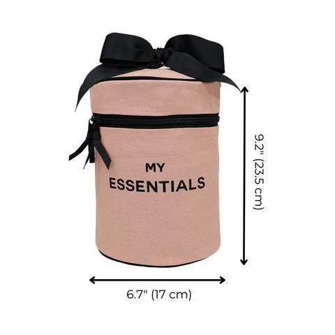 Bag-all Roomy Travel Essentials Case in pink with black bow, cylindrical design, featuring water-resistant lining and 'MY ESSENTIALS' text print, perfect for cosmetics and toiletries