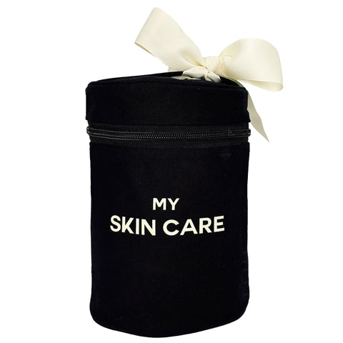 Bag-all Round Skin Care Case with Handle in black cotton featuring cream bow, white text 'MY SKIN CARE', zippered compartment for beauty storage and organization
