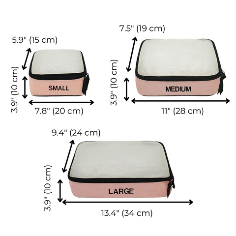 Three pink blush cotton packing cubes in small, medium, and large sizes with black zippers and white mesh tops.