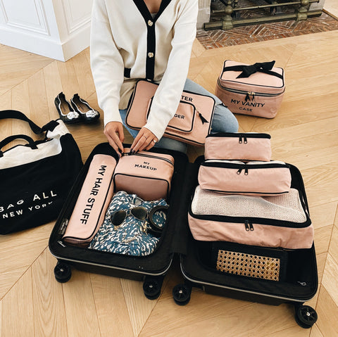 Bag-all Cotton Packing Cubes in Pink/Blush, set of 3 sizes with mesh tops shown organized in open suitcase, featuring travel-ready storage for clothes and accessories