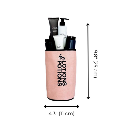 Bag-all Lotions & Potions Liquid Travel Case in blush pink with waterproof lining, displaying toiletry bottles inside. Cylindrical design measuring 9.8" height and 4.3" width