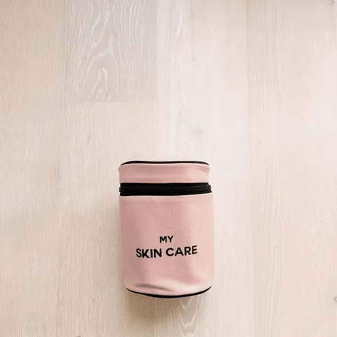 Bag-all Round My Skin Care Case in blush pink with black text, cylindrical organizer with laminated lining and internal pockets, perfect for skincare storage