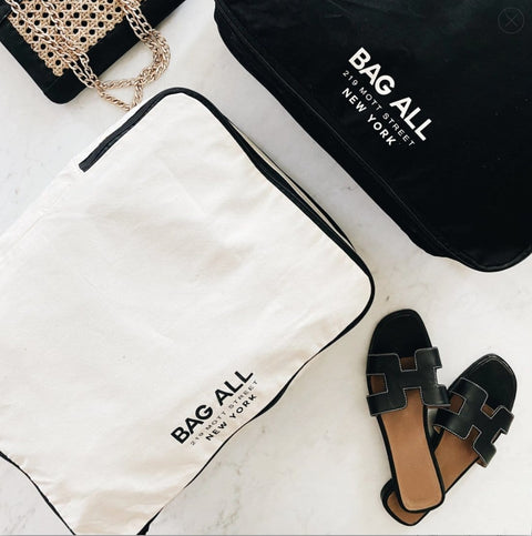 Bag-all Large Packing Cube in cream with double compartments and shoe storage, shown with black sandals and brand dustbag. Perfect travel organizer for efficient packing.