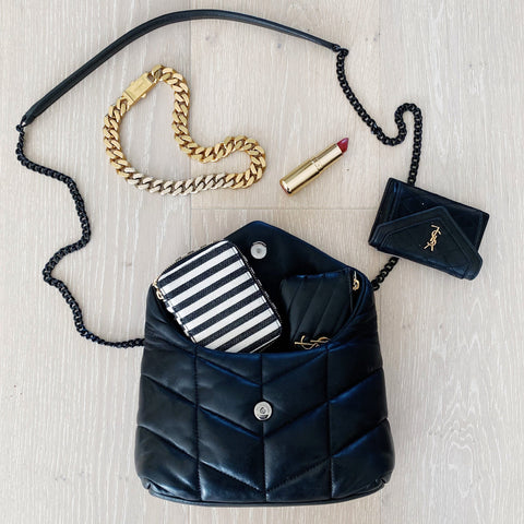 Bag-all striped Jewelry/Trinket Box with quilted black handbag, gold chain bracelet and lipstick on white wooden surface, showing organized storage solution