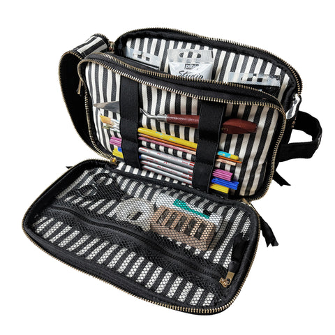 Cream triple travel and hobby organizer with striped interior, mesh pockets, elastic bands, and various stationery inside