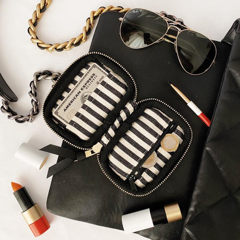 Bag-all Small Wallet Pink/Blush with Black Piping featuring striped interior compartments, gold zipper detail, and organized card slots, styled with sunglasses and lipstick for everyday elegance
