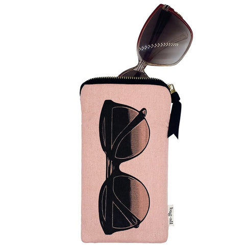 Bag-all Glasses Case with Outside Pocket in blush pink featuring sunglasses print, gold zipper, and extra storage pocket. Protective case with stylish design for eyewear storage.