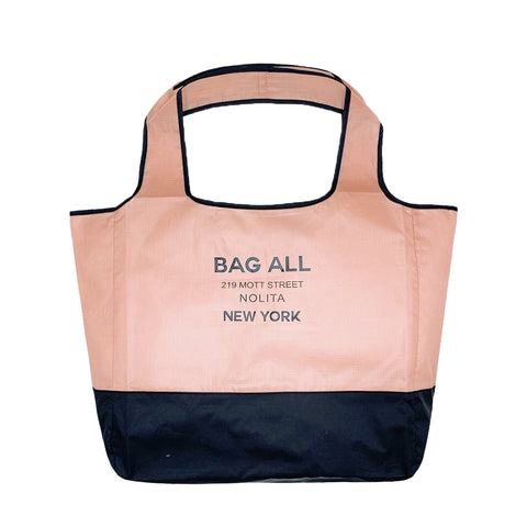 Bag-all Folding Shopping Bag in pink and black nylon with zipper pocket pouch, featuring brand logo and New York address, eco-friendly reusable design