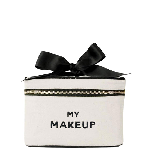 Bag-all My Makeup Cosmetic Box in cream canvas with black bow and zipper detail, perfect for organizing beauty essentials and travel toiletries