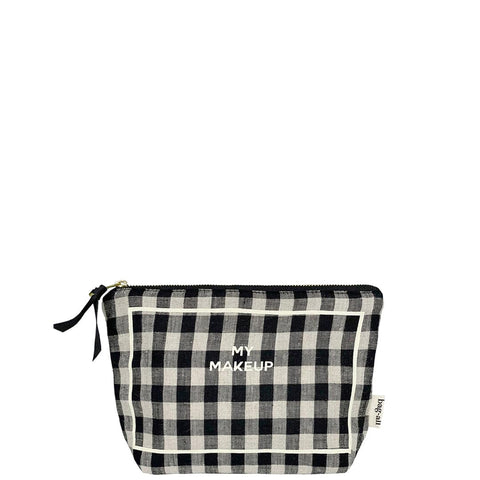 Bag-all My Makeup Pouch in black and white gingham pattern with coated lining, gold zipper and MAKEUP text print. Travel-sized cosmetic case for organizing beauty essentials.