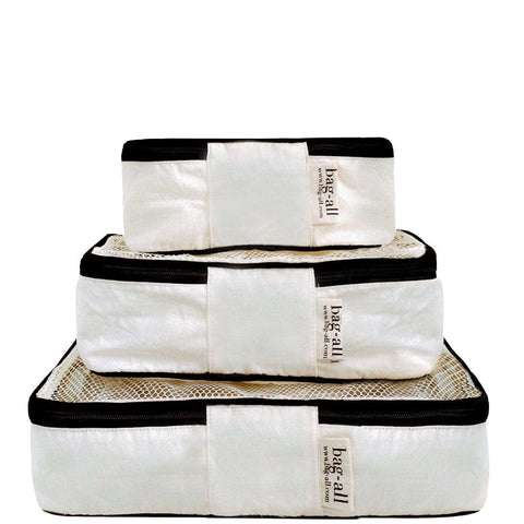 Bag-all Cotton Packing Cubes in cream with black trim, set of 3 nested sizes featuring mesh tops for visibility and breathability, perfect for organized travel storage